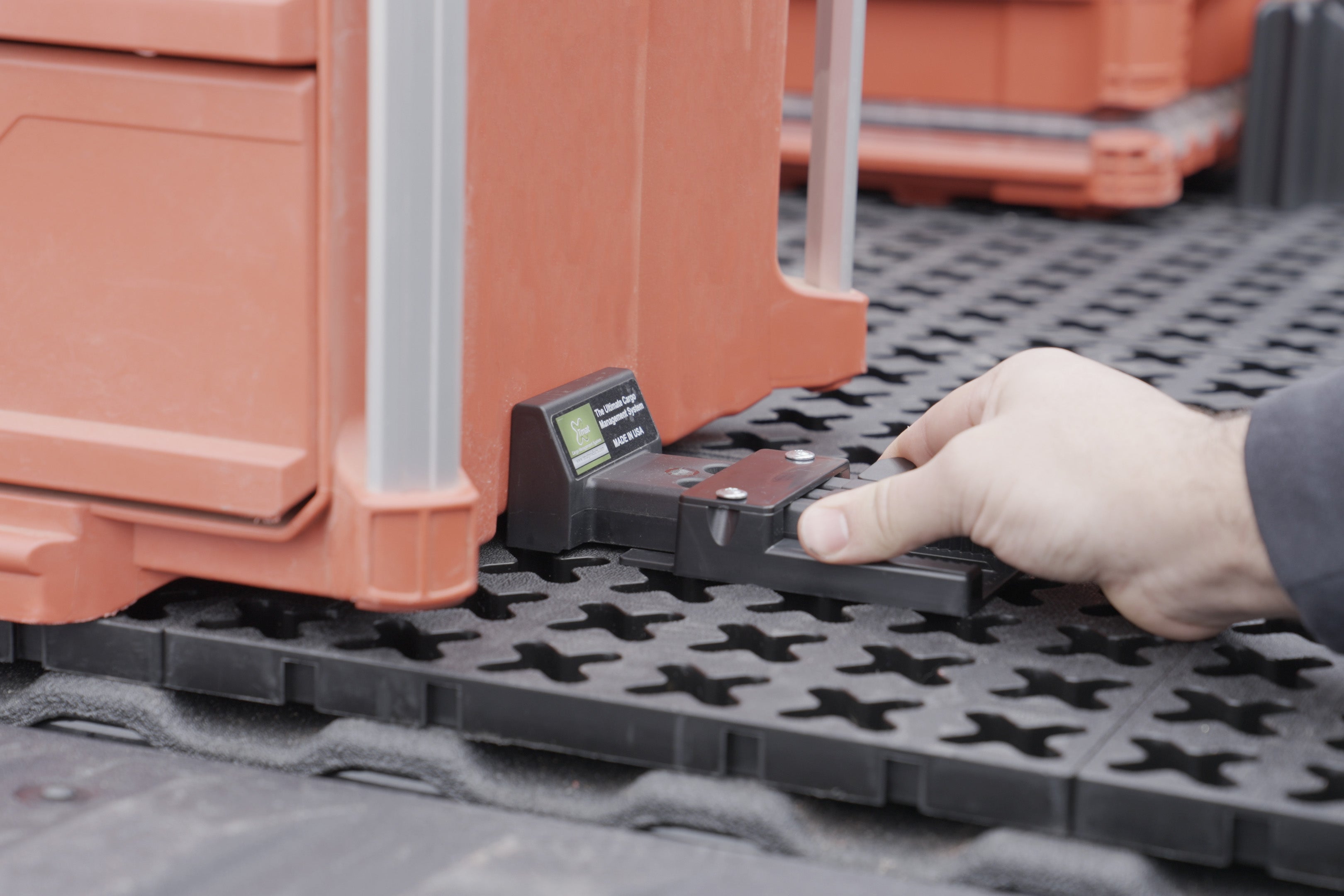 A Tmat Adjustable Blocker securing a Milwaukee Packout toolbox.